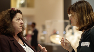two women in discussion at an event